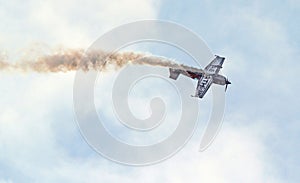Aerobatic plane. Smoke trail as it does stunts.