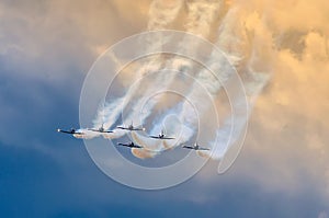 Aerobatic team aircraft fighters trail of smoke in the sky.