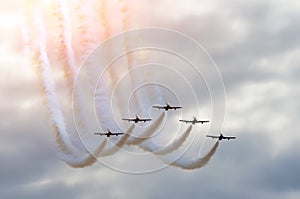 Aerobatic team aircraft fighters trail of smoke in the sky.