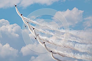 Aerobatic team at airshow. Flight demonstration and formation flying. Air force and military show. Airport and air base