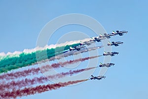 Aerobatic team in formation during aerobatic flight with tricolor smoke