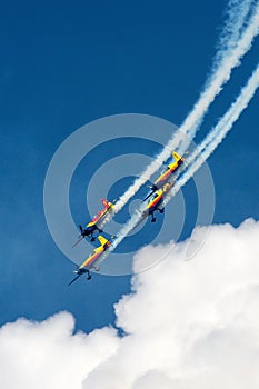 Aerobatics celebration with 3 planes on a clear day. Red, yellow and blue airplanes performing stunts in the air. photo