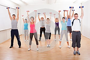 Aerobics class working out with dumbbells