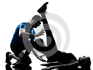 Aerobics intstructor with mature woman exercising silhouette
