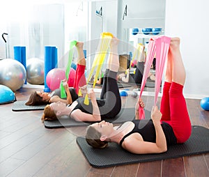 Aerobics pilates women with rubber bands in a row