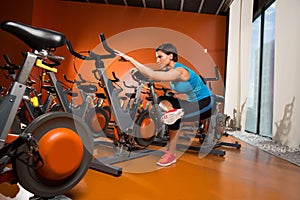 Aerobics spinning woman stretching exercises after workout