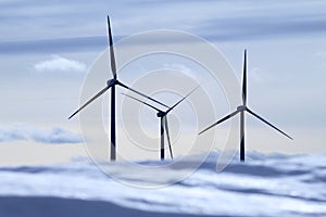 Aerogenerator electric windmills snow mountain photo
