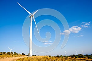 Aerogenerator wind mill in sunny blue sky photo