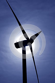 Aerogenerator windmill backlight blue sky photo