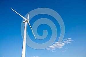 Aerogenerator windmill in blue sky photo