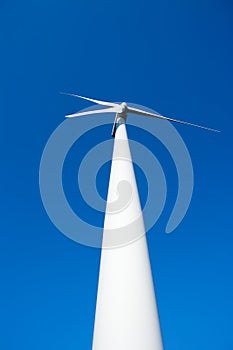 Aerogenerator windmill in blue sky photo