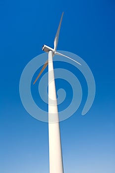 Aerogenerator windmill in blue sky photo