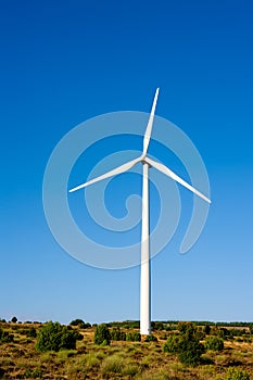 Aerogenerator windmill in sunny blue sky photo