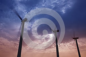 Aerogenerator windmills on dramatic sunset sky photo