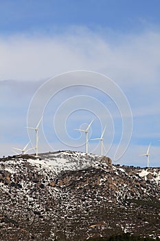 Aerogenerator windmills on snow mountain photo