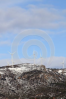 Aerogenerator windmills on snow mountain