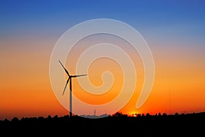 Aerogenerator windmills on sunset sky photo