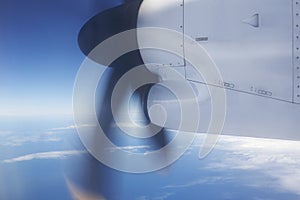 Aeroplane flying over the ocean and turbine detail in movement