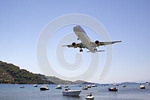 Aeroplane flying in over Skiathos old harbour, Skiathos Town, Greece, August 18, 2017