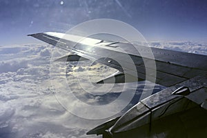 Aeroplane wing on a background of blue sky on a sky background