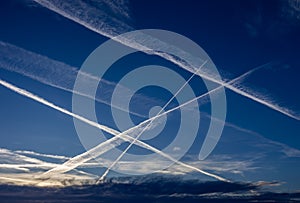 Aerosol airplane waves in blue sky