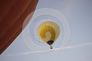 Aerostatic balloon rising up from sky  and birds flying with it photo