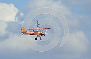 Aerosuperbatics  wing walking display team aeroplane in flight. Wing walker upside down.