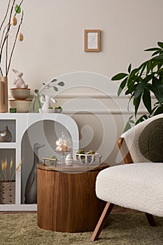 Aesthetic composition of easter living room interior with boucle armchair, round pillow, vase with leaves, easter bunny, coffee