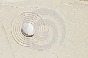 Aesthetic minimal background with zen stone on sand. Pattern in Japanese Zen Garden