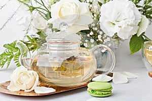 Aesthetic morning table setting. Green tea, macaroon desserts, white bouquet. Time for yourself, slow living concept.