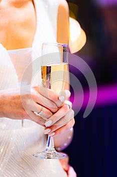 Aesthetic shot of woman in white clothes holding glass of wine