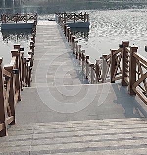 Aesthetic stairs with unique wooden decorations that lead to the pier