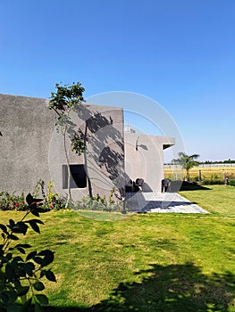 Aesthetically built luxury villa and it's green lawn in the winter afternoon sunlight photo