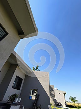 Aesthetically built luxury villa and it's green lawn in the winter afternoon sunlight photo