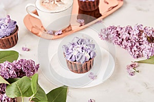 Aesthetics close up purple floral cupcakes using trend Dreamy Escapism. Desserts and flowers background