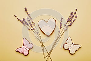 Aesthetics spring cookies with lavender. Baked glazed symbols of Easter on yellow background. Spring card top view.