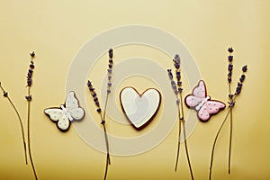 Aesthetics spring cookies among lavender. Spring card top view. Baked glazed symbols of Easter on yellow background.