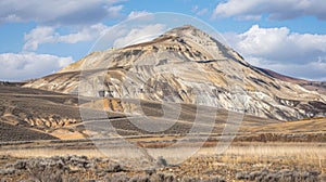 From afar it appears that the mountain has been painted with a haphazard brush as streaks of exposed earth and piles of photo