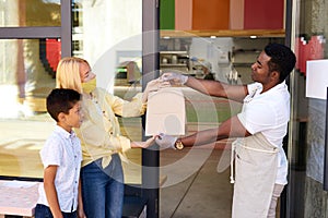 Affable cafe worker serve clients, give takeaway orders