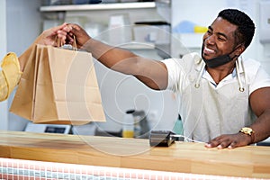 Affable cafe worker serve clients, give takeaway orders