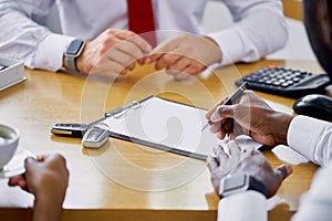 Affable caucasian salesman show the document to customers