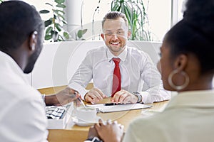 Affable caucasian salesman show the document to customers