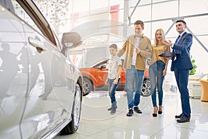 Affable consultant represent new car for clients in dealership