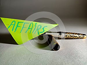 affairs text displayed on green colour paper slip pen pen isolated
