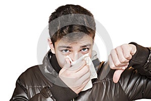 Affected by cold teenager wipes his nose with handkerchief on white background