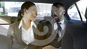 Affectionate business woman and man flirting in car, office romance, affair