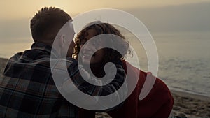 Affectionate couple dating on sea beach at sunrise. Girl running along coastline