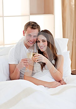 Affectionate couple drinking champagne