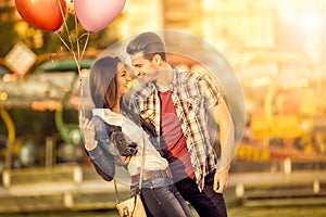 Affectionate couple having fun in amusement park photo