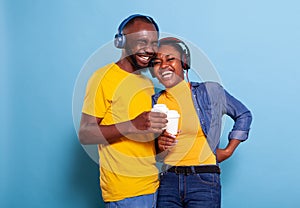 Affectionate couple having fun with mp3 music on headphones